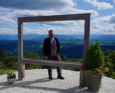 Wooden picture frame at Hohenpeißenberg, Alps on the horizon