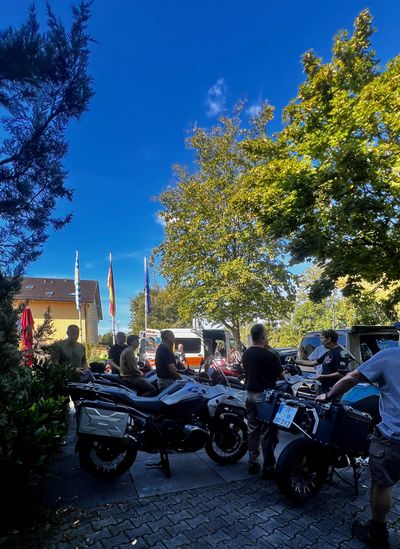 Riders getting BMWs ready under Bavarian and German flags