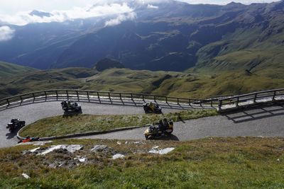 Three-wheelers working cobbled hairpins on the high alpine road