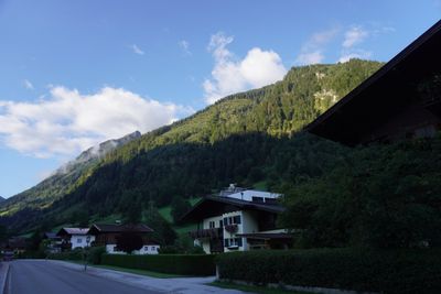 Village street and rooftops under a bright alpine sky