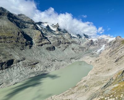 Closer view of the silt-green Pasterze lake and rock walls