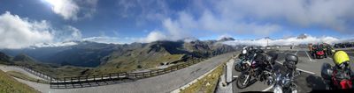 Panorama from a Glockner overlook, bikes parked above a sea of clouds