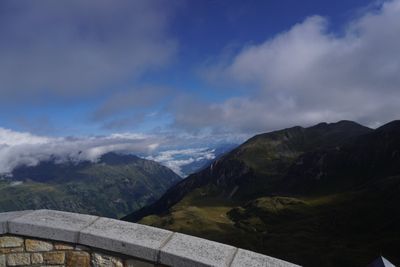 Stone wall along the Glockner road with peaks beyond