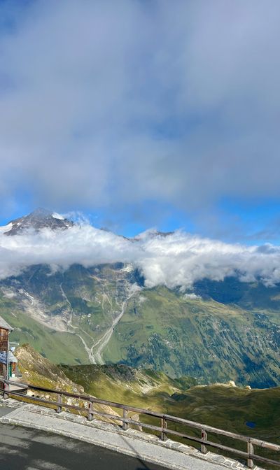Wooden railing overlook with a peak sitting in the cloud deck