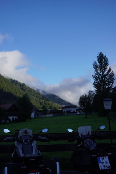 Touring bikes parked against a green alpine valley in Heiligenblut