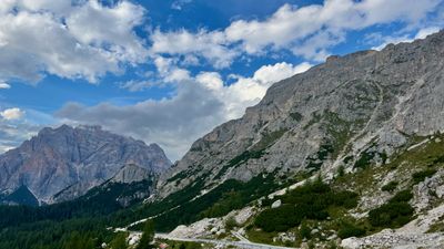 Mountain road and pale Dolomite walls near Passo Valparola