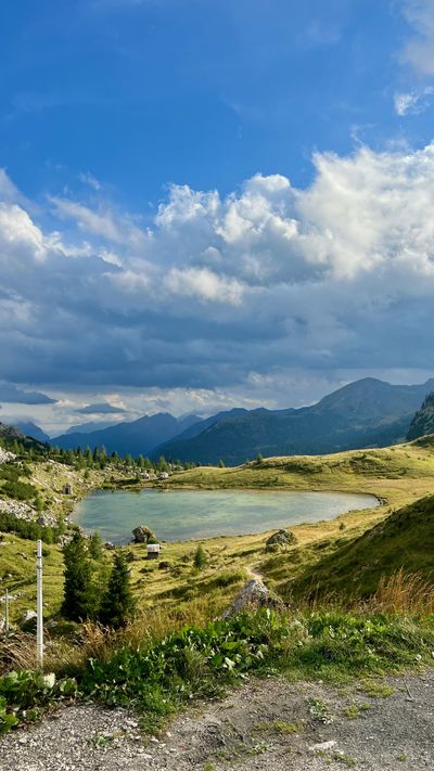 Small turquoise tarn in a green basin below Valparola