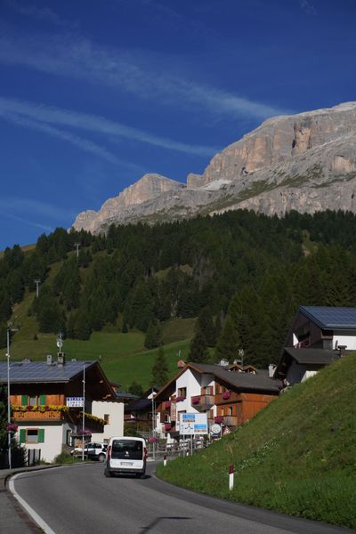 Alpine village with a rocky peak behind the rooftops