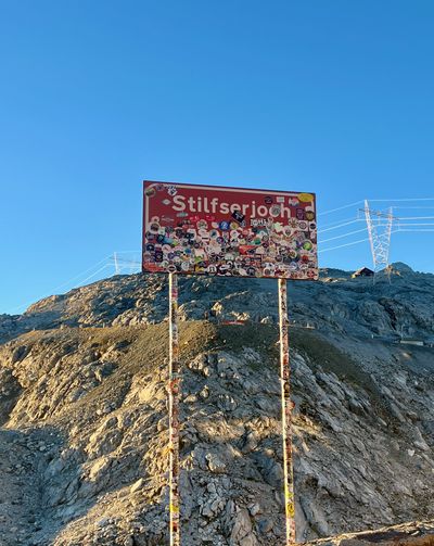 Summit sign silhouetted on the Stelvio