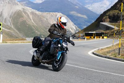 Leaning through a Stelvio hairpin, Ortler in the distance