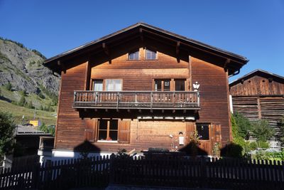 Chalet balcony overflowing with pink flowers