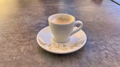 Small espresso on a grey stone table