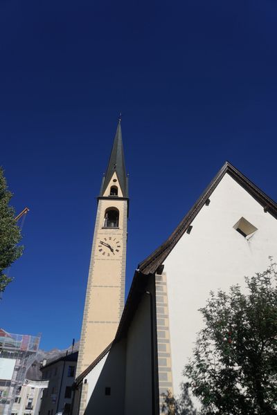 Tall white church steeple against a blue sky