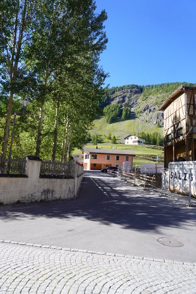 Narrow village road between white Engadin houses